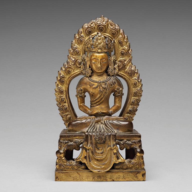 A gilt bronze seated figure of Amitayus, Qing dynasty, Qianlong period, dated by inscription.