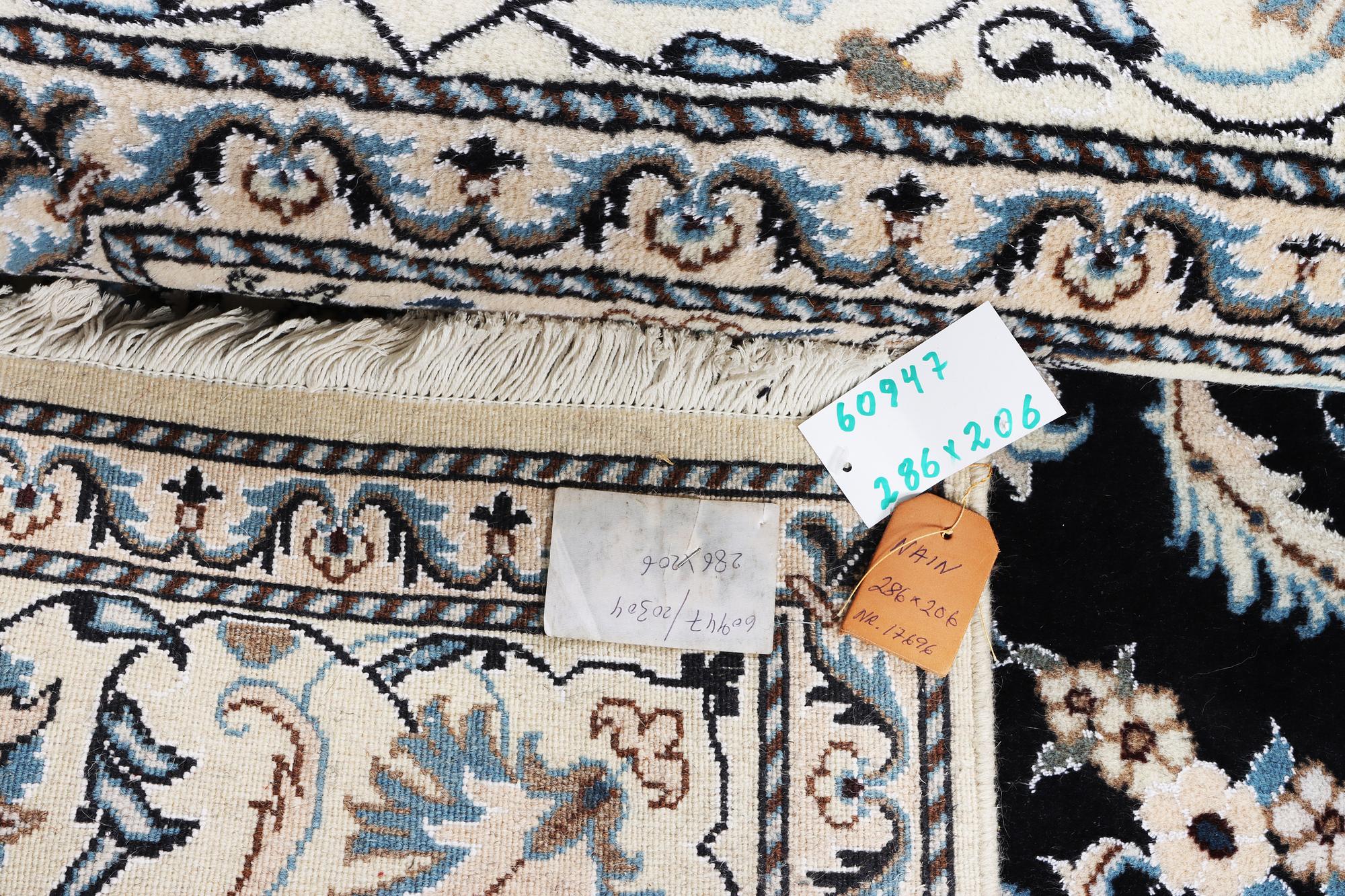 A Nain carpet, part silk, c. 286 x 206 cm.