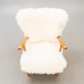 A 1940s sheepskin armchair.