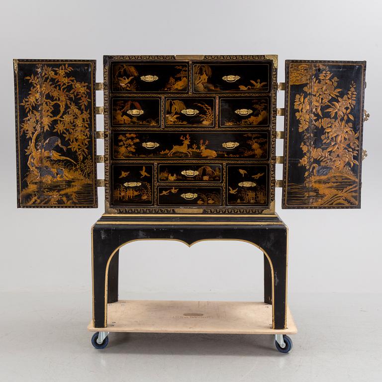 AN early 18TH CENTURY PROBABLY ENGLISH Japanned laquer cabinet on stand.