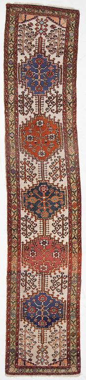 An oriental runner, c. 395 x 82 cm.