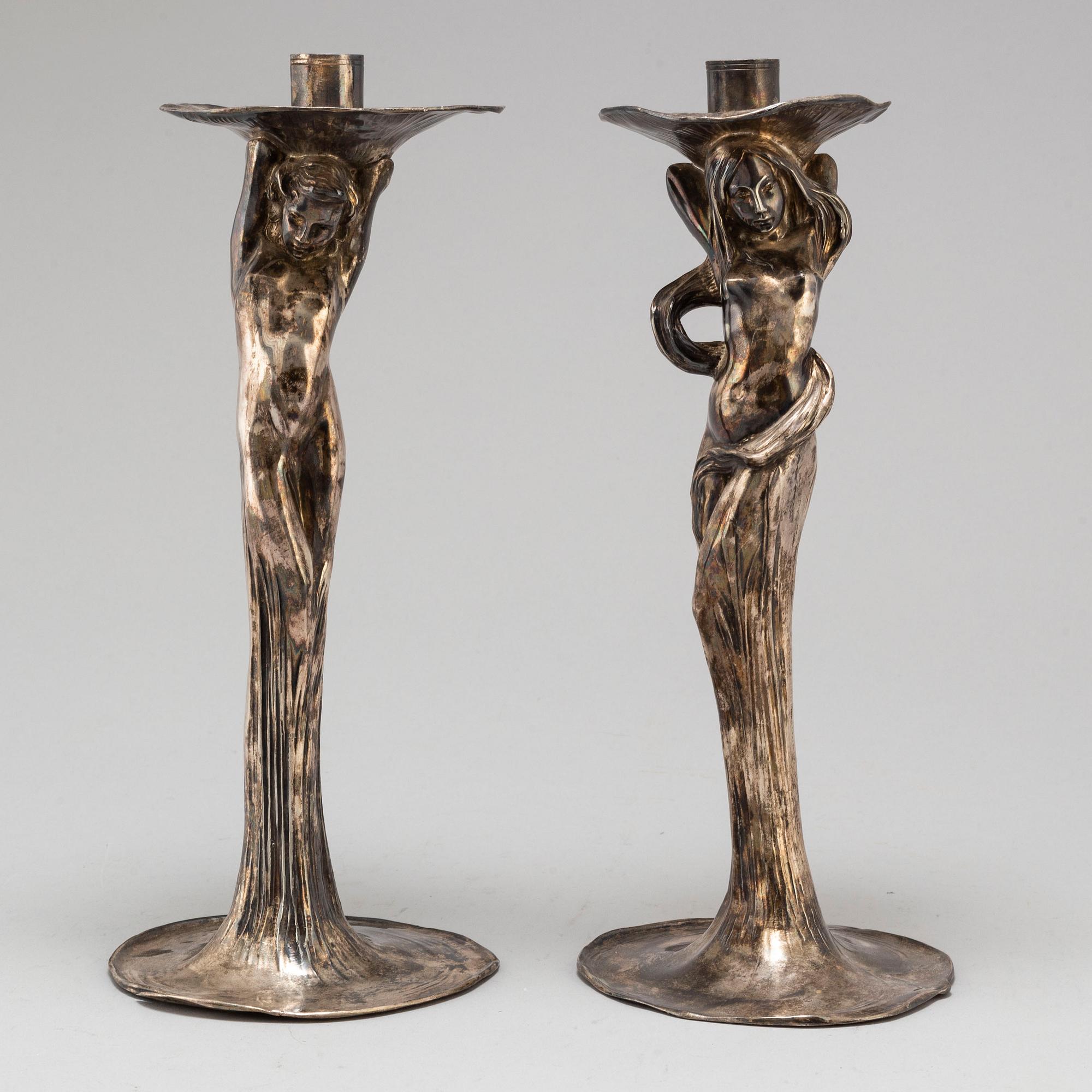 A 20th Century pair of art noveau style candle sticks marked A.W.OX.