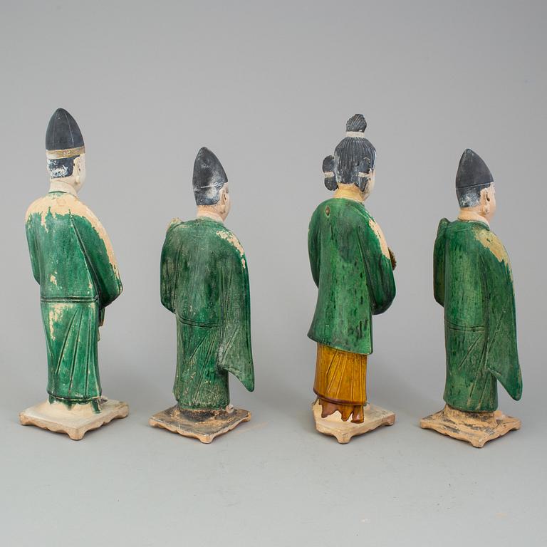 A group of eight chinese figures with three objects, earthenware, Ming dynasty.