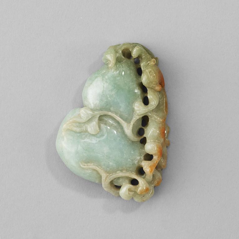A Chinese nephrite sculpture of a qilin dragon on top of a gourd.