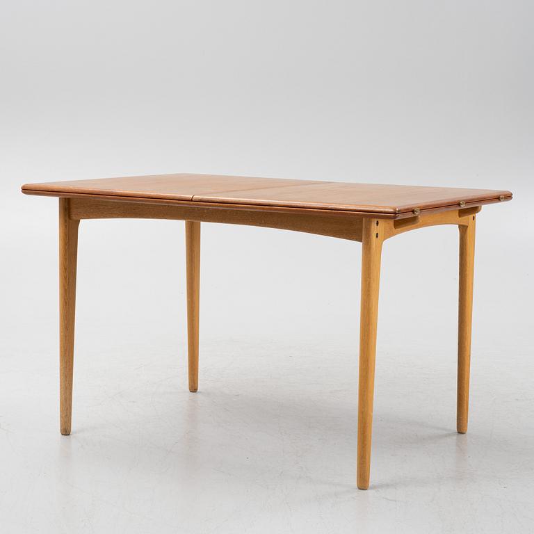 A 1960's teak and rosewood veneered dining table.