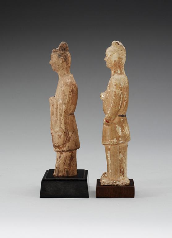 Two glazed pottery figurines of standing officials, with traces of paint, Tang dynasty (618-907).