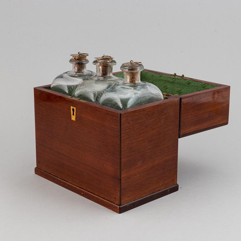 A late Empire mahogany box with three glass bottles, mid 19th Century.