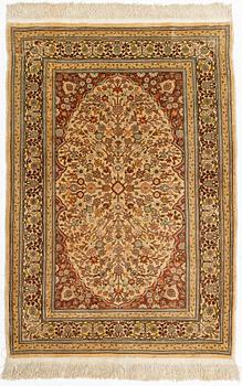 A silk Hereke rug, circa 104 x 70 cm.