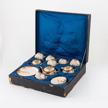 A box with a Japanese satsuma tea service, signed, early late Meiji (1868-1912). (15 pieces).