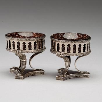 A pair of Swedish 19th century porphyry and silver salt-cellars, silver with mark of Gustaf Folcker, Stockholm 1823.