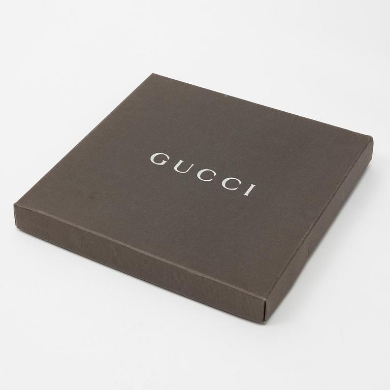 Gucci, a silk scarf.