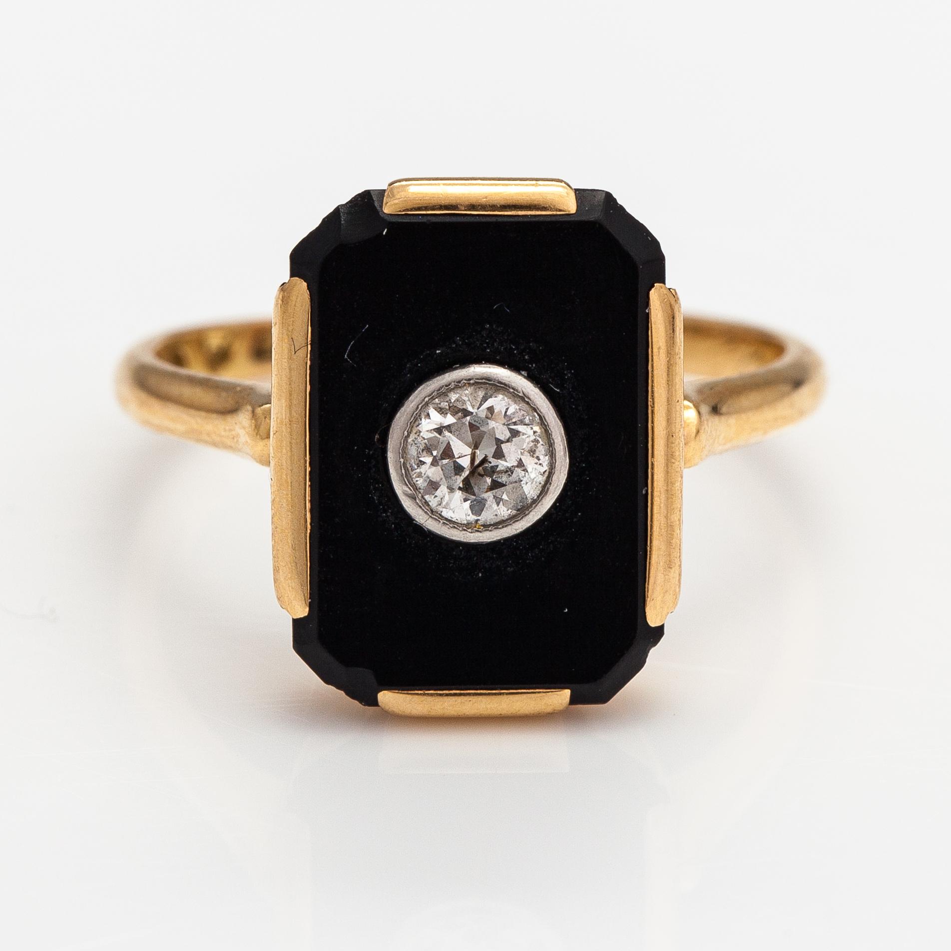 An 1(K gold ring with an onyx and an old-cut diamond ca. 0.18 ct. Westerback, Helsinki 1938.
