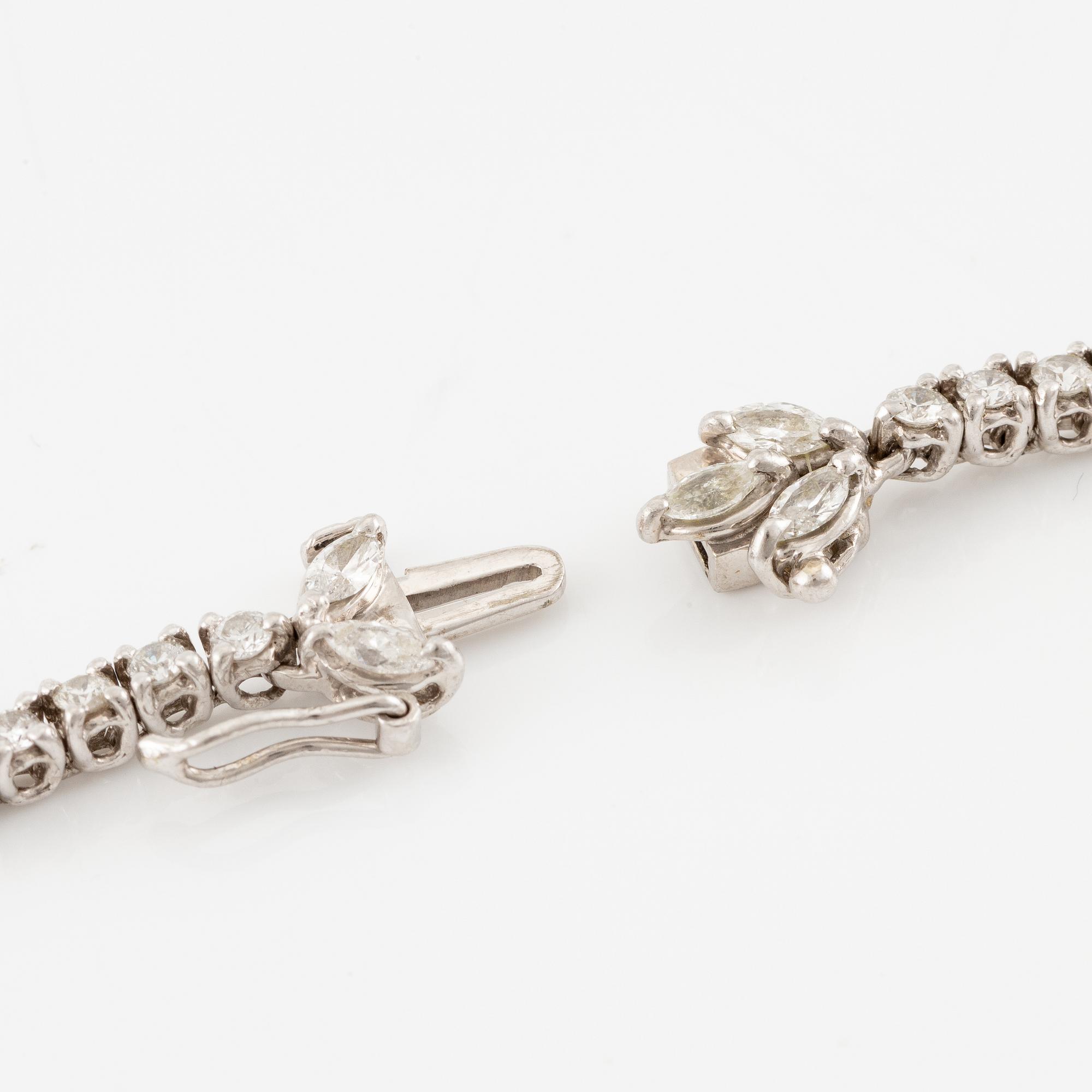 A platinum necklace set with navette-, pear- and round-brilliant-cut diamonds.