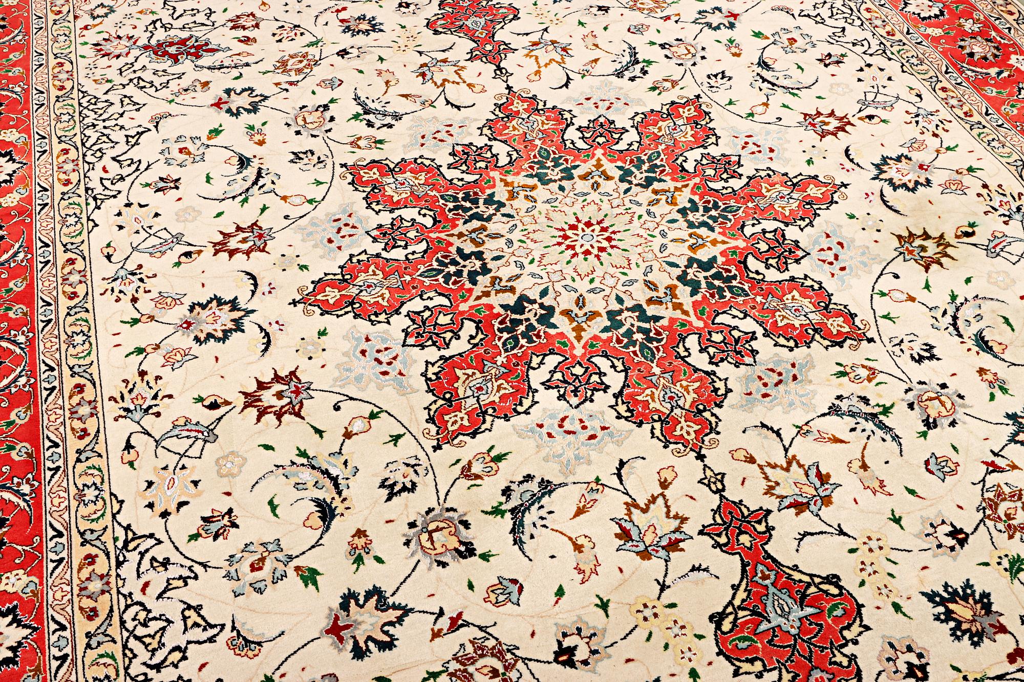 A Tabriz, part silk carpet, c. 300 x 199 cm.