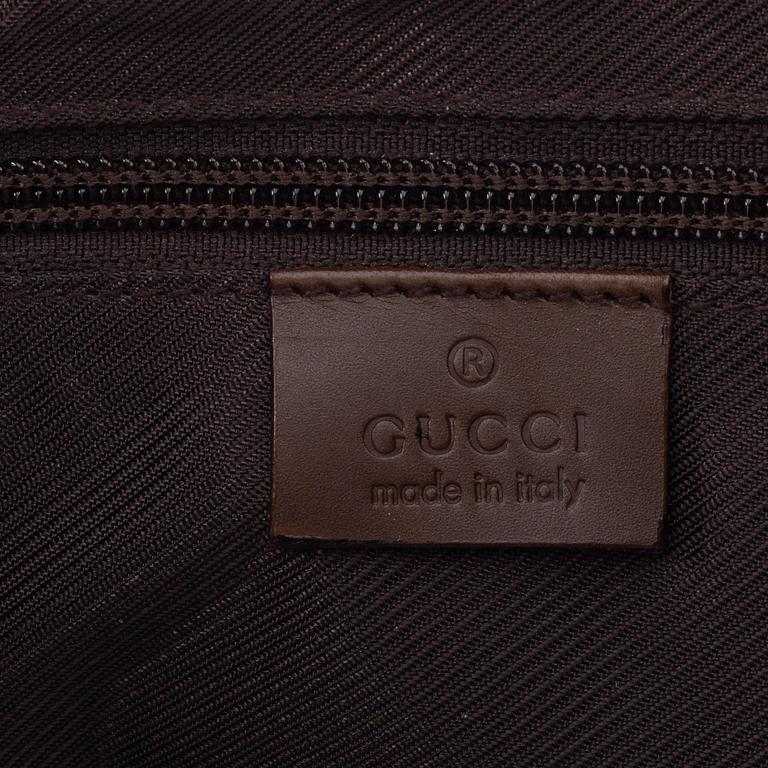 Gucci, a canvas handbag.