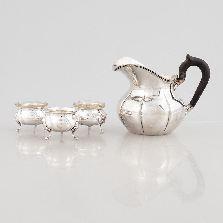 A Danish silver jug and three salt cellars, first half of the 10th Century.