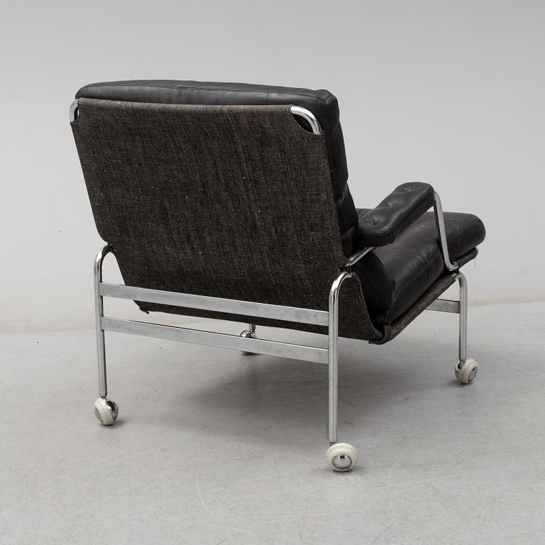 BRUNO MATHSSON, a "Karin" black leather easy chair.