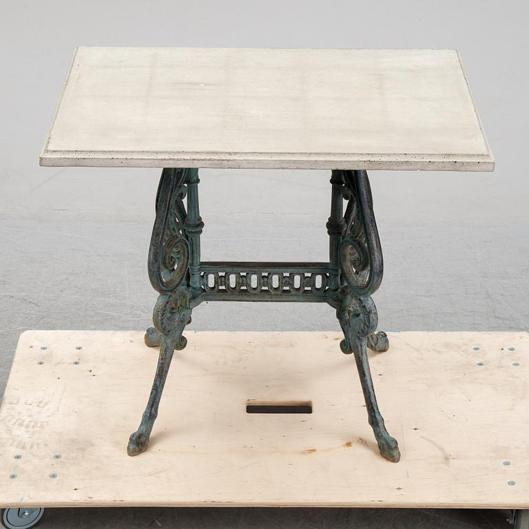 A early 20th Century cast iron garden table with later concrete top.