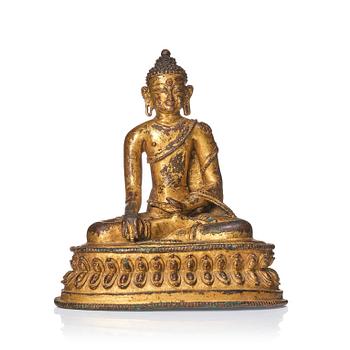 1006. A gilt copper alloy figure of Buddha, Tibet/Nepal 15th Century.