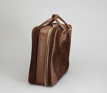 A 1970s brown suede suitcase by Gucci.