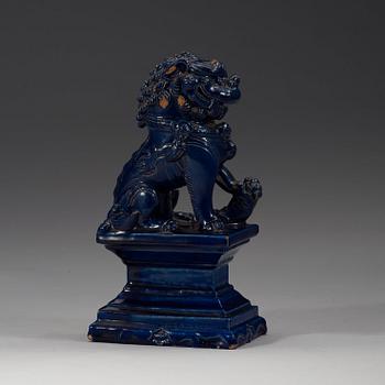 A seated blue glazed buddhist lion, Ming dynasty, 17th Century.