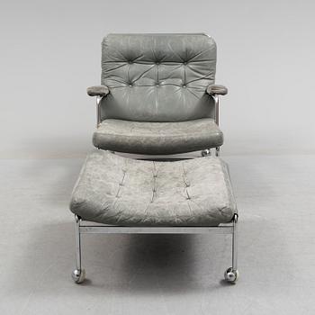 A second half of the 20th century easy chair and footstool.