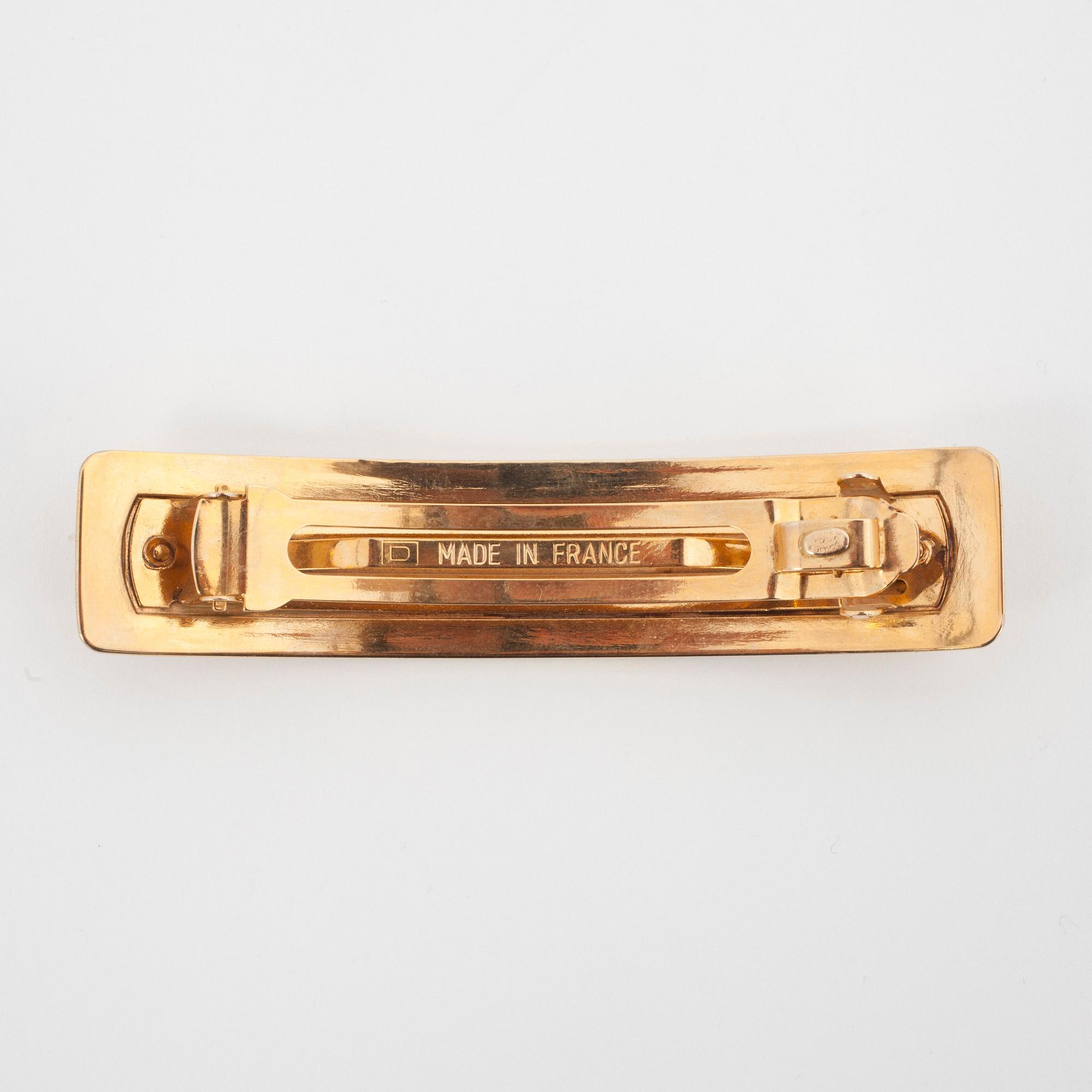 CHANEL, a gold colored metall hair clip.