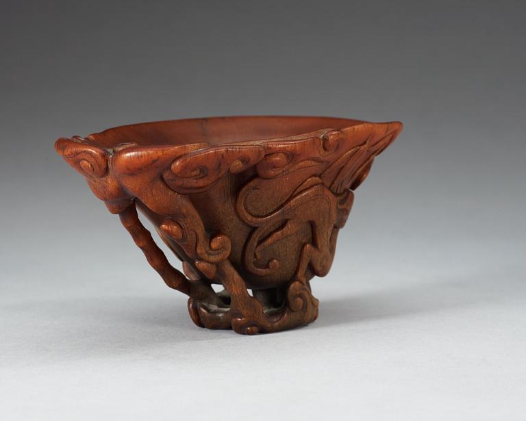 A finely carved rhinoceros libation cup, Qing dynasty, Kangxi (1662-1722).