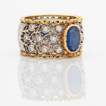 A Buccellati ring in 18K gold and white gold set with a faceted sapphire and round brilliant-cut diamonds.