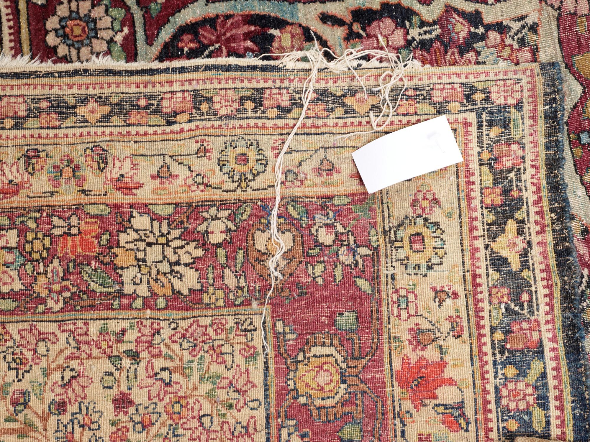 An antique Kerman Laver carpet, c. 586 x 385 cm.
