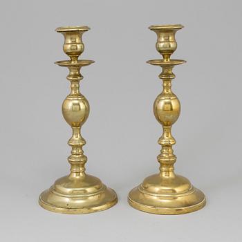 A PAIR OF BRONZE CANDLESTICKS, early 19th century.