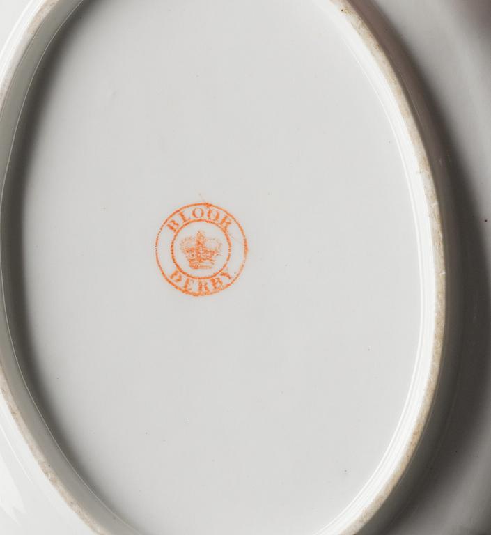 A pair of armorial butter tureens with covers and stands and two fruit dishes, Derby, England, circa 1830.