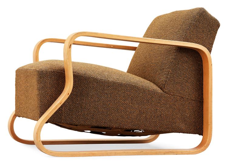 An Alvar Aalto laminated birch 'padded Paimio chair', upholstered in yellow and black fabric.