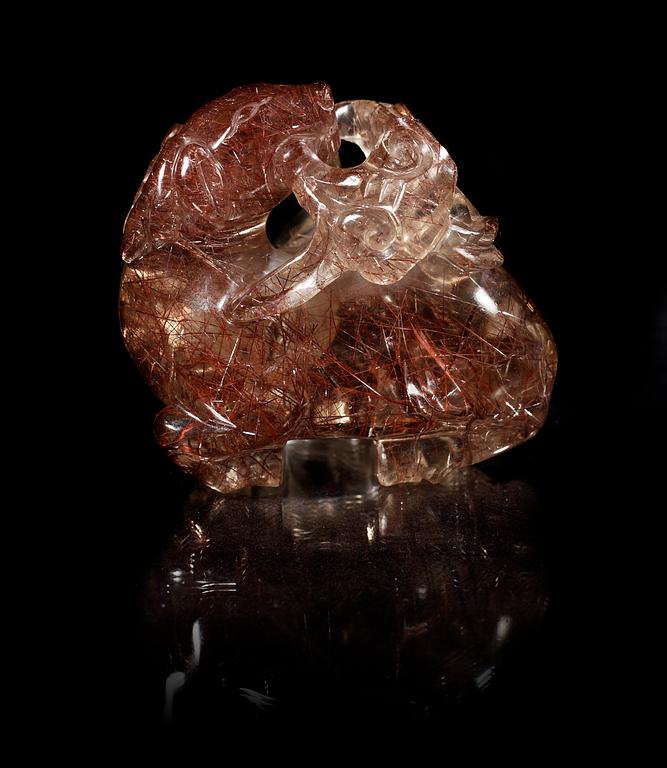 A carved quartz figure of a reclining deer with a dog and som fungus, China, early 20th Century.