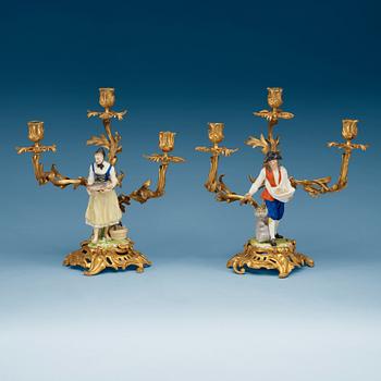 872. A pair of bronze candelabra with porcelain figures, French/English, second half of 19th Century.