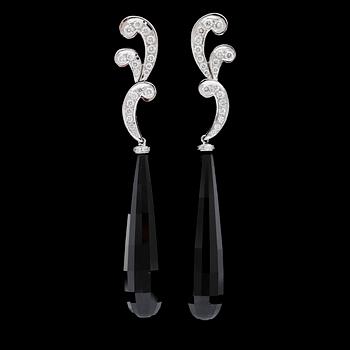 114. A pair of onyx and brilliant cut diamond earrings, total carat weight circa 0.73 cts.