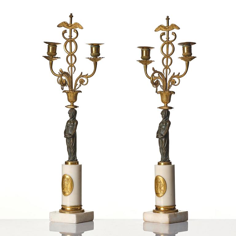 A pair of late Gustavian white marble and bronze candelabra.