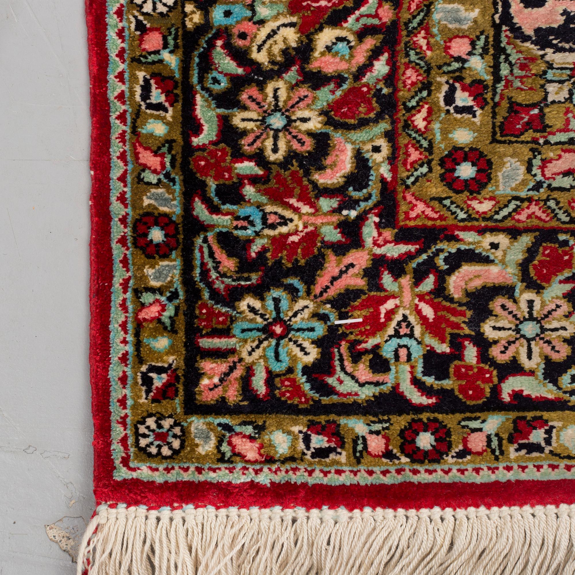 A silk Qum rug, around 114 x 80 cm.