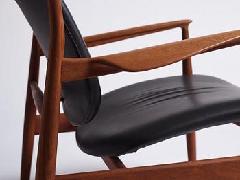 Finn Juhl, a teak and black leather 'model 136' easy chair, France & Daverkosen, Denmark 1950-60s.