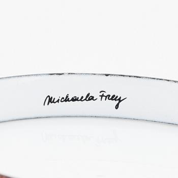 A bangle by Michaela Frey with multi-coloured enamel decoration.