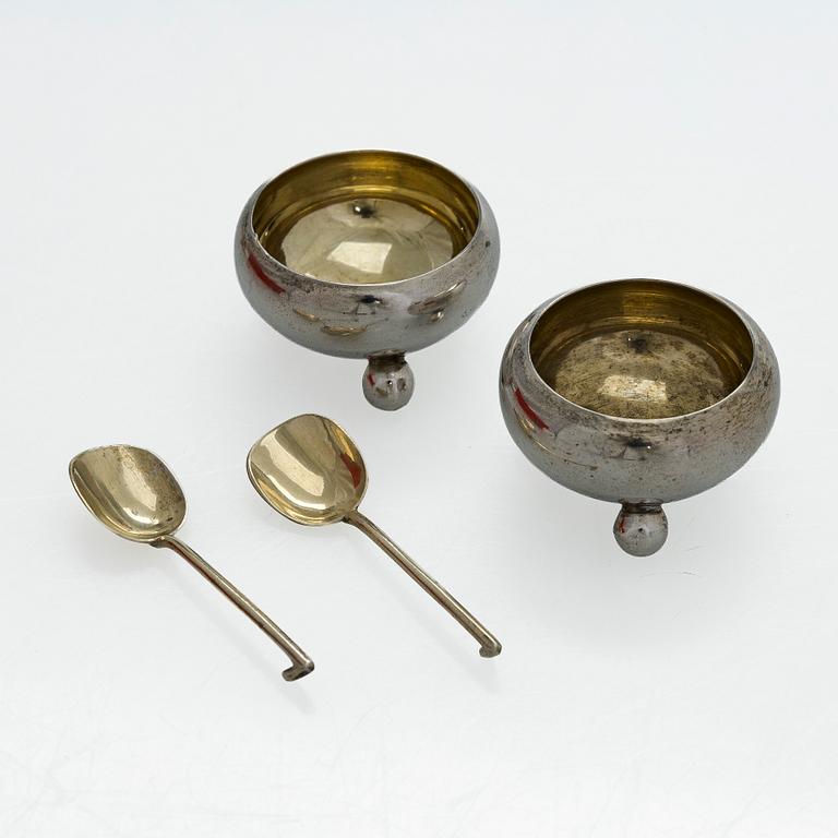 A pair of Russian silver salt cellars, a sprinkle spoon, a sauce ladle, and a tea strainer, Finnish marks.