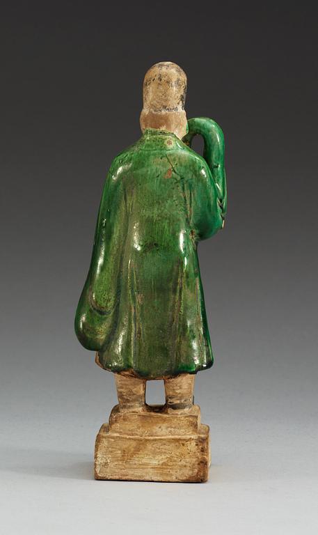 A green glazed figure of a man, Ming dynasty.