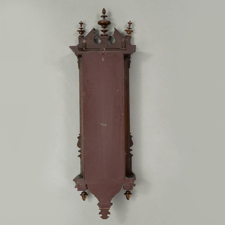 A late 19th century wall pendulum clock.