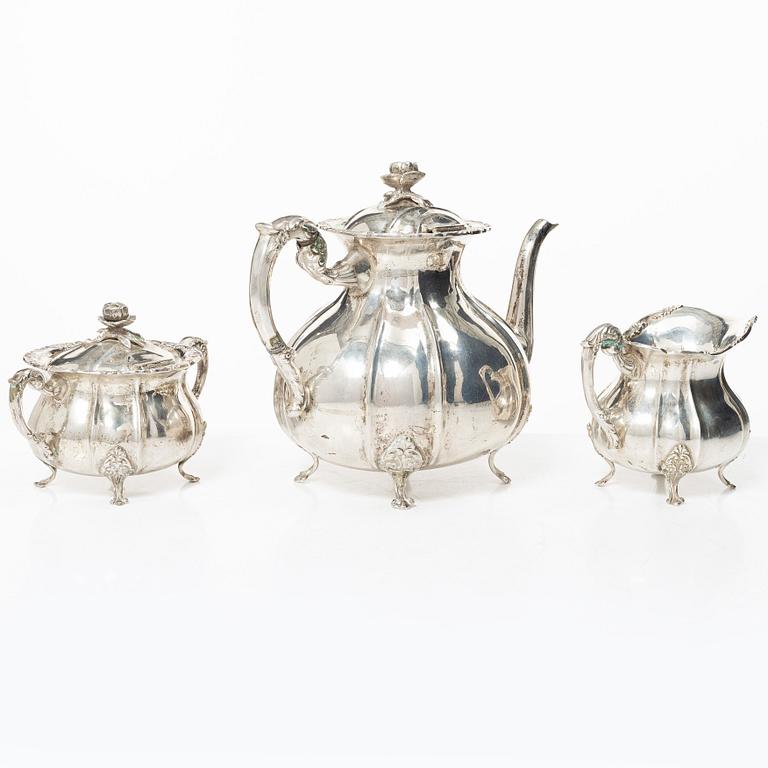 A Rococo style silver coffee pot, cream jug and sugar bowl, 20th century, Swedish import mark.