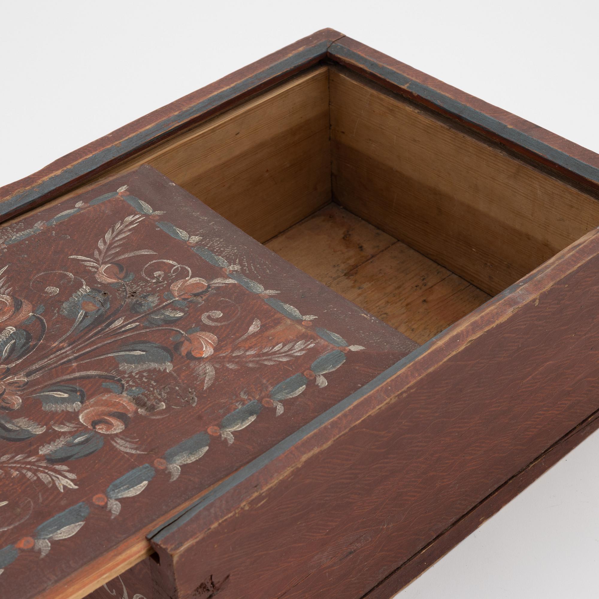 A Swedish folk art painted box with sliding lid, dated 1829.