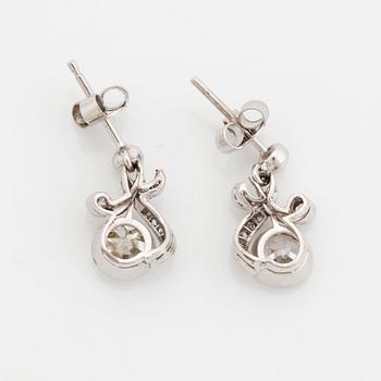 A pair of 18K white gold earrings set with old-cut diamonds.