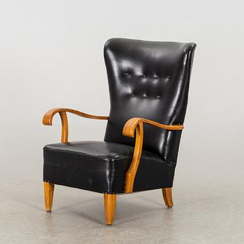 A 1940's - 50's easy chair in black leather, Scandinavian.