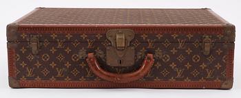 A monogram canvas suitcase by Louis Vuitton.