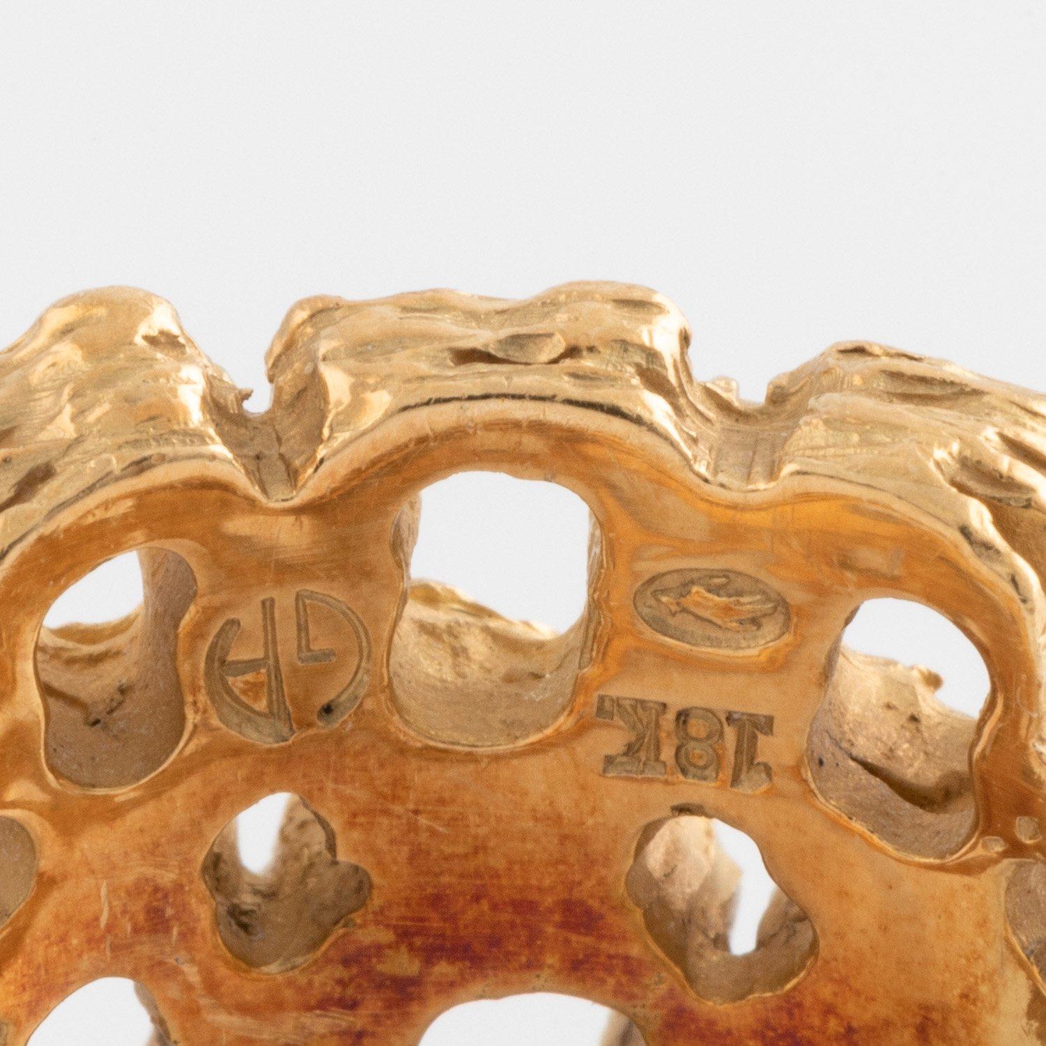 A Gilbert Albert ring in 18K gold.