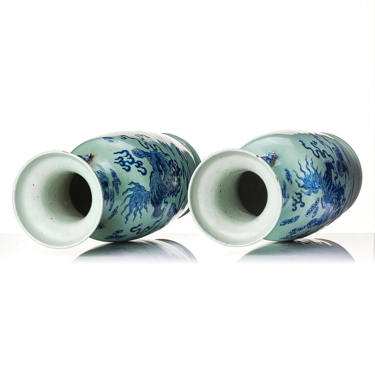 A pair of blue and white vases with celadon ground decorated with Buddhist lions, late Qing dynasty/circa 1900.